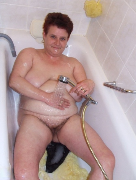 Chubby housewife Ingeborg plays with her saggy breasts in the bathroom
