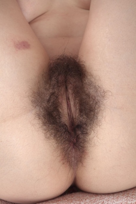 Natural brunette Effy getting naked and showcasing her super furry pussy