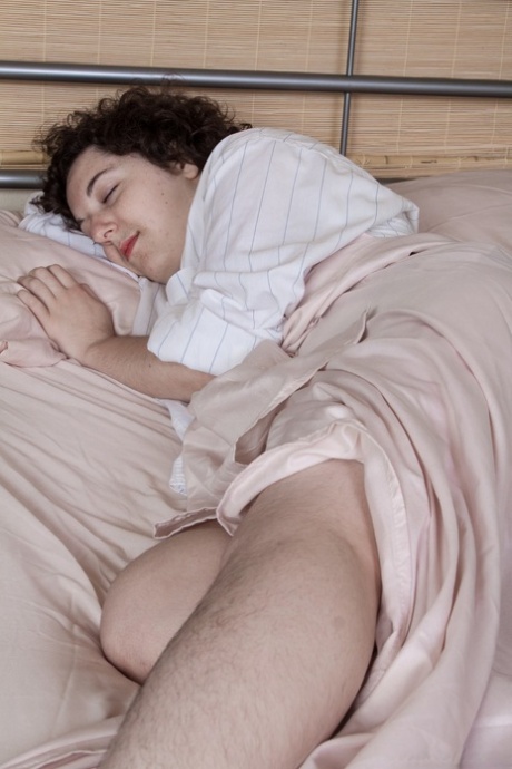 Nasty brunette Tamar showing her hairy legs and cunt in solo in the bedroom