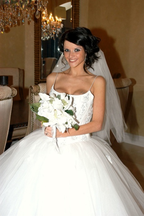 Slender bride Joslyn James reveals her big fake tits on the wedding bed