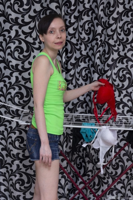 Slim mature Trixie reveals her hairy pussy and small tits after ironing