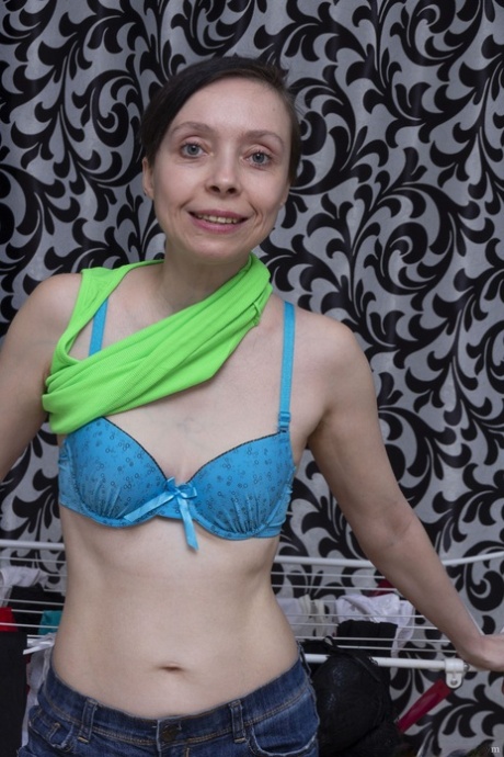 Slim mature Trixie reveals her hairy pussy and small tits after ironing