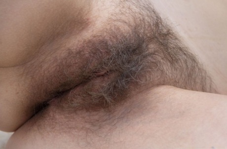 Slim mature Trixie reveals her hairy pussy and small tits after ironing