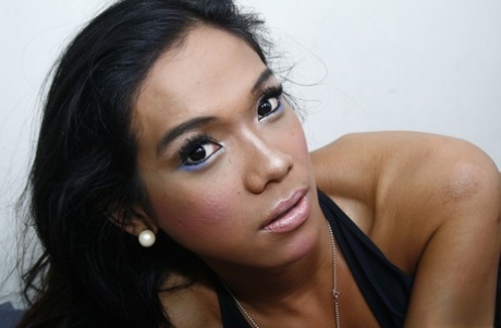 Exotic Thai shemale Denden goes bottomless and strokes her hairy penis