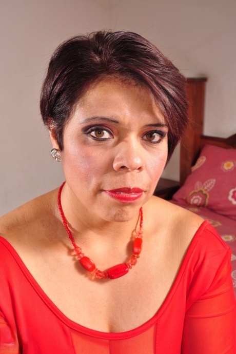 Sexy mature in a red dress Faby sucks a stiff boner and shows her hairy pussy