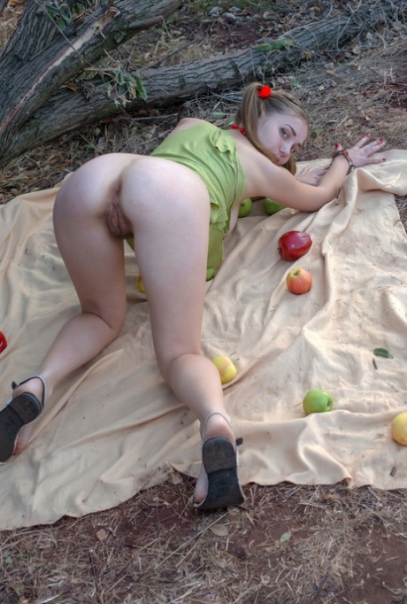 Pigtailed teen Anastasija bares her big natural tits and bushy twat in nature