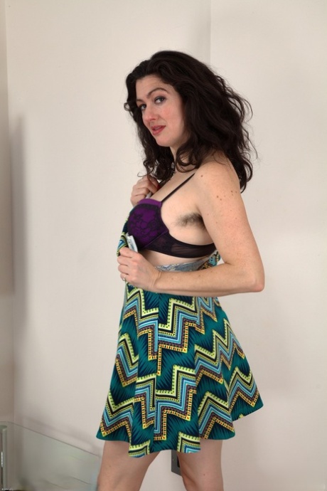 Tall brunette Sadie Lune taking her clothes off & exposing her hairy body