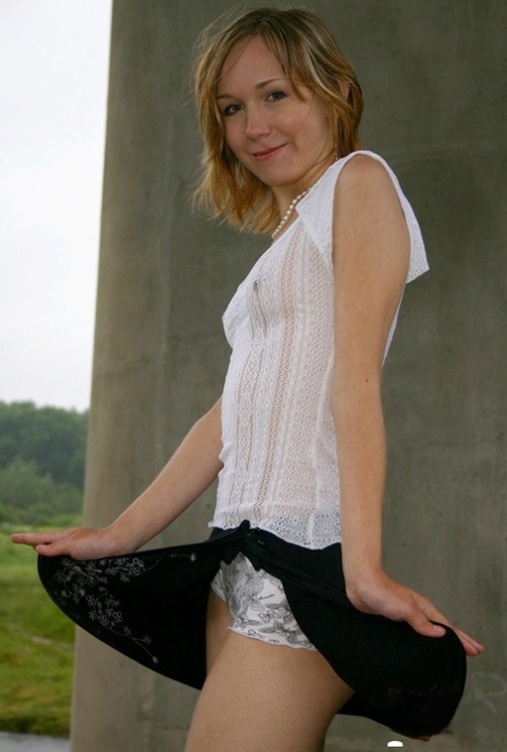 Skinny MILF undresses to show her tiny tits & her little bald cunt outdoors