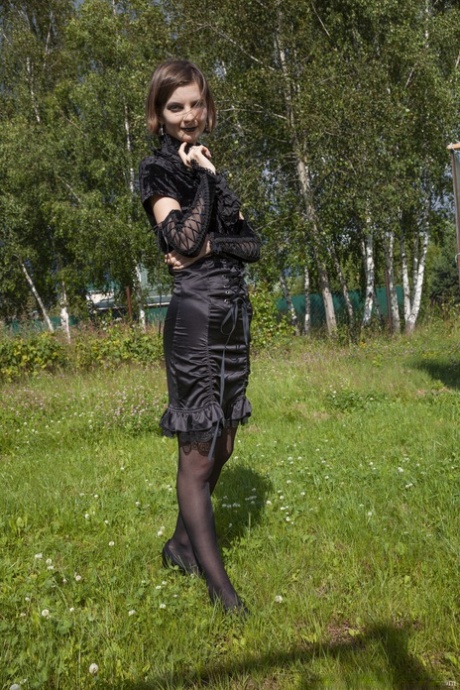 Gothic beauty Lady Phanthom stripping & spreading her furry pussy outdoors