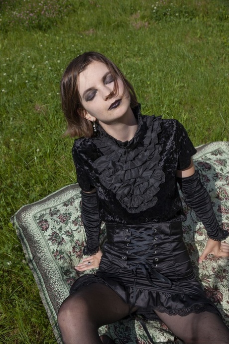 Gothic beauty Lady Phanthom stripping & spreading her furry pussy outdoors