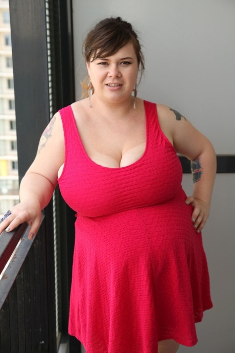 Chubby brunette Roxanne Miller shows her fat belly and monster boobs in a solo