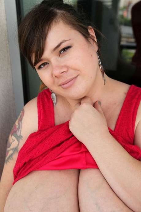 Chubby brunette Roxanne Miller shows her fat belly and monster boobs in a solo