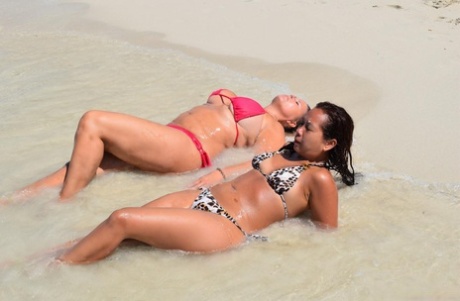 Mature lesbian MILFs pose in their sexy bikinis and show off their boobs