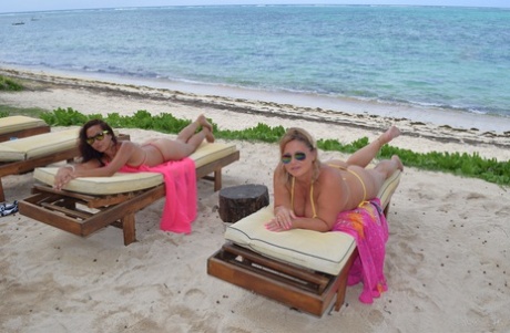 Mature lesbian MILFs pose in their sexy bikinis and show off their boobs