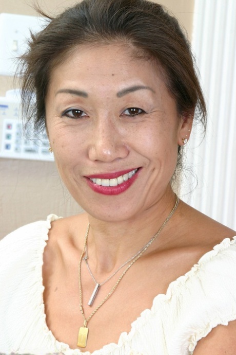 Exotic Asian lady Hana shows her tiny natural tits and furry pussy