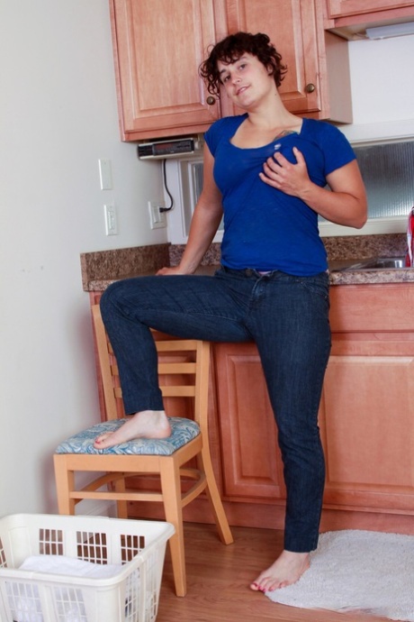 Filthy housewife Valerie teases with her hairy crotch and armpits in a kitchen