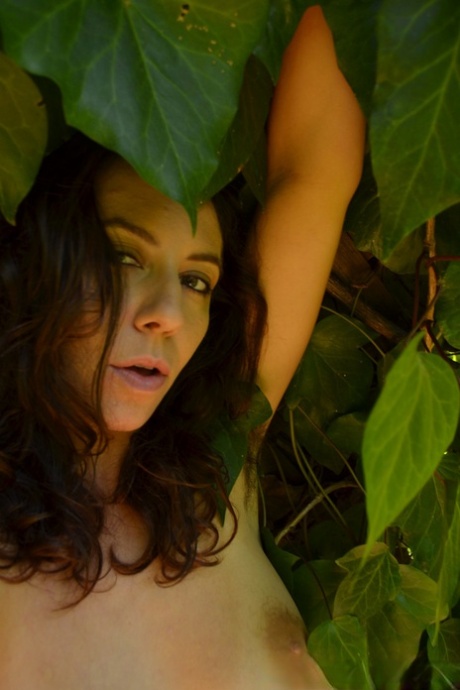 Brunette amateur Nikki Silver licks her feet and toys her hairy pussy outdoors