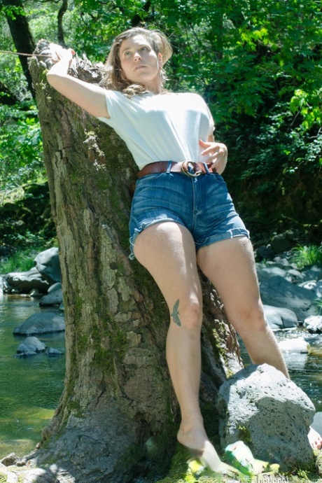 Amateur teen with a hairy body Cookie undresses and poses outdoors