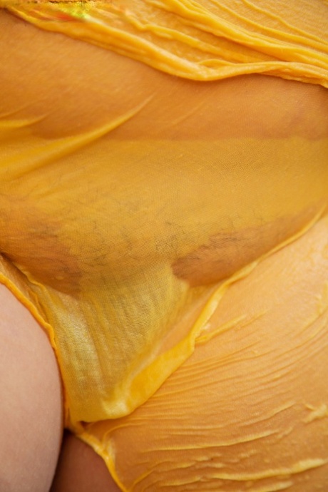Fatty Andreea strips and shows her monster curves while watering the plants