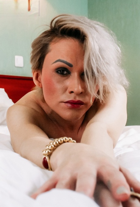 Mature Russian shemale loses her red lingerie and toys her asshole
