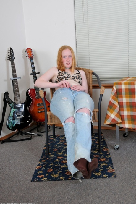 Amateur teen Sandy strips and fingers her furry muff while sitting on a rug