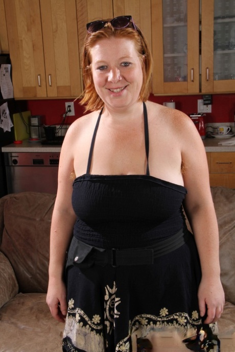 Charming mature redhead Carolyn unveils her fat body & hairy twat in a solo