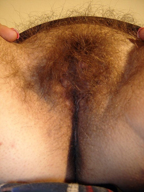 Chubby amateur teen Amber undressing and spreading her super furry pussy