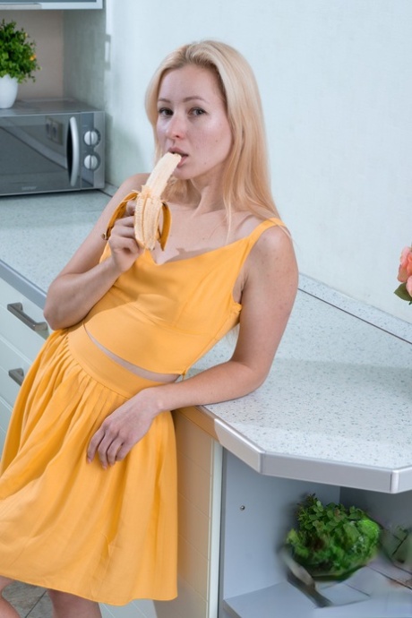 Sexy amateur doll Sati strips & shows her hairy coochie after eating a banana
