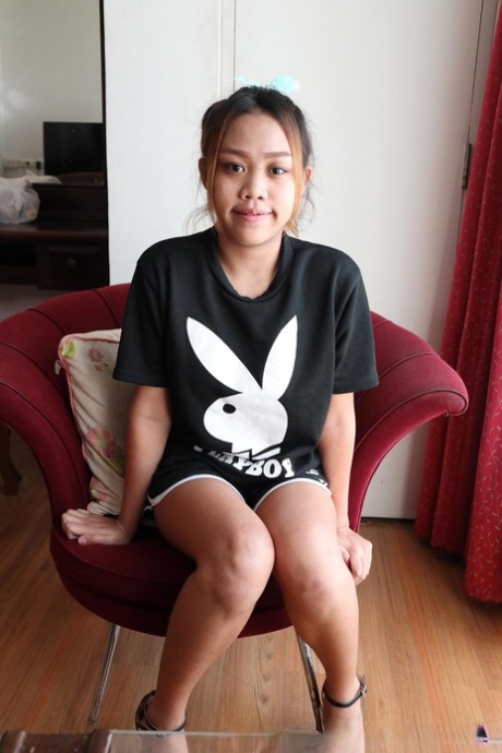 Beautiful Asian girl Em shows her small breasts and her hairy pussy