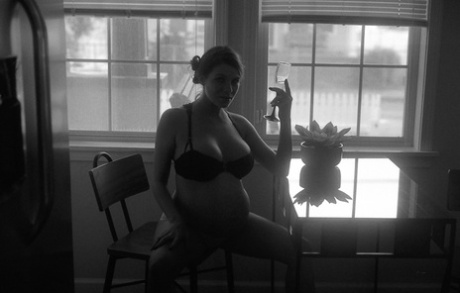Pregnant woman masturbates with a vibrator in an erotic B&W scene